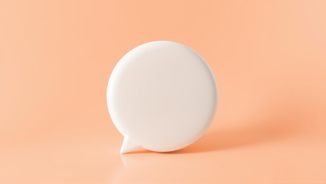 Minimalist image shows white speech bubble object resting on peach background. Simple studio lighting creates soft shadows.