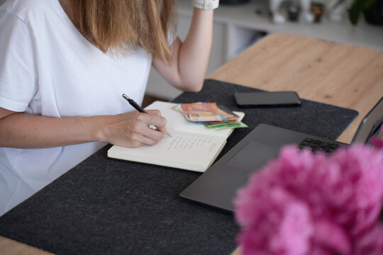 Woman planning household budget and expenses at home