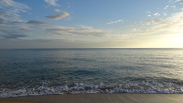 Beautiful Early Morning Sky and Sea View with Soft Clouds.
A picturesque early morning scene featuring soft clouds in the blue sky and gentle waves rolling onto the sandy beach of the East Sea.
