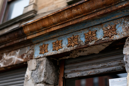 Weathered industrial facade with oxidized metal and aged architectural details, authentic urban realism,, rendered in sharp detail with beautiful natural lighting