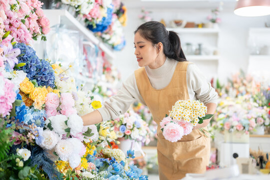 florist shop woman apron peony daisy bouquet arrangement selection asian retail store business work