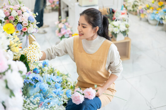 florist shop woman apron peony bouquet arrangement selection sitting asian retail store business work