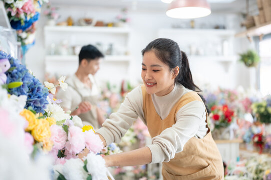 florist shop woman in apron smile happy arrangement selection asian business work colorful display