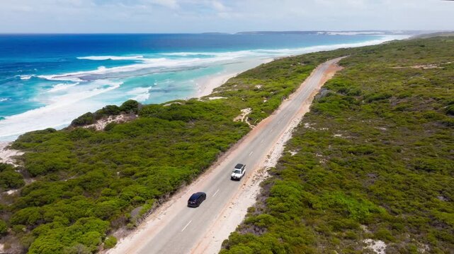 A car driving along the Nine Mile Lagoon filmed with a drone, Esperance, Australia