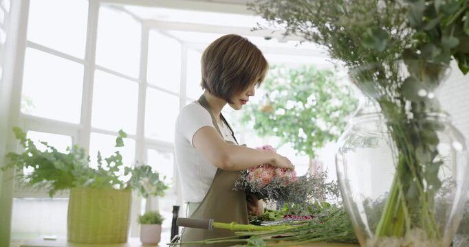 Startup successful sme small business entrepreneur owner asian woman standing table with flowers at florist shop service job. Portrait of asian girl successful owner environment friendly