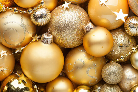 Monochrome  backgraund  of  golden Christmas  ornaments different sizes, shades and textures. Flay lay