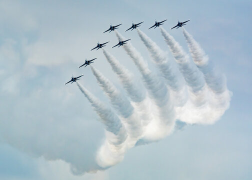 Aerial view of Changi Exhibition Centre featuring a formation of Korea Black Eagles fighter jets performing an aerobatic display with white smoke trails in Singapore, Singapore.