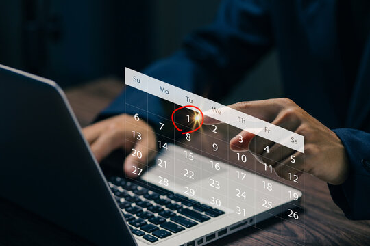 Business professional selecting a date on a virtual calendar interface above a laptop, illustrating online scheduling, appointment planning, time management, and digital productivity.