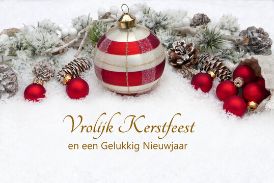 Nederlandse kerstkaart met rood-witte kerstballen in de sneeuw en het opschrift &lsquo;Vrolijk Kerstfeest en een Gelukkig Nieuwjaar&rsquo;.