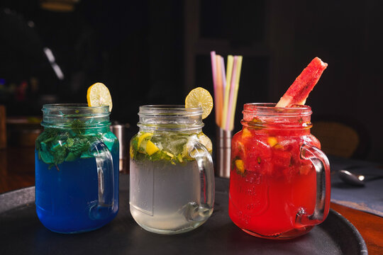 Refreshing and colorful healthy cool drinks served with fresh lemon slices and watermelon garnish. A vibrant summer beverage concept representing freshness, hydration, natural ingredients, healthy lif