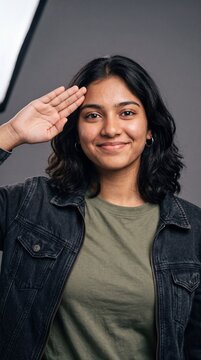 Young South Asian Female Teenager Performing Salute Gesture