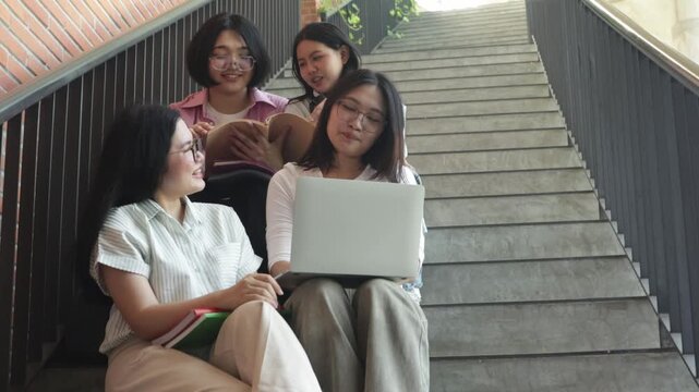 Group cheerful asian male and female students carrying backpacks and textbooks sit steps academic building smile and wave camera in front university building ready begin university studies.