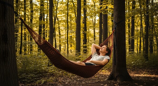 Person relaxing in a hammock among lush green forest trees