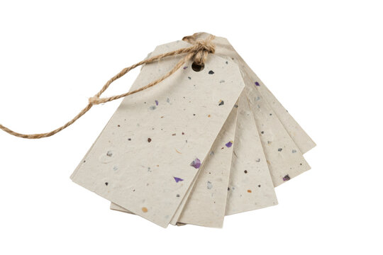 Set of recycled paper gift tags with speckled texture and natural jute twine tied in a knot for product labeling isolated on a transparent background