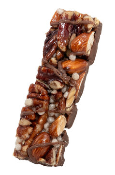 Bar with peanuts, hazelnuts, caramel and chocolate on a white background. View from above. Nut bar isolate. Sugar