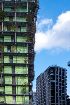 Green apartment tower with a residential facade in Paris France forming a cityscape with apartment architecture against the sky and a green tower in the cityscape