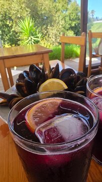 refreshing summer *tinto de verano* drink with steamed mussels and lemon, traditional cuisine