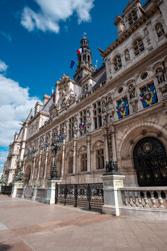 H&ocirc;tel de ville in paris, historic city hall building displaying french and european flags under a blue sky