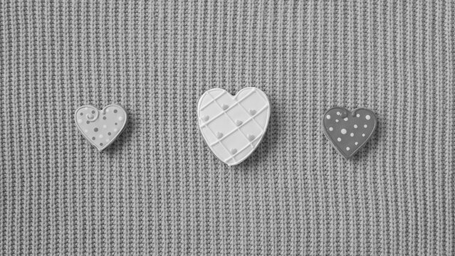 Decorative Heart Ornaments on Cozy Knitted Fabric Background