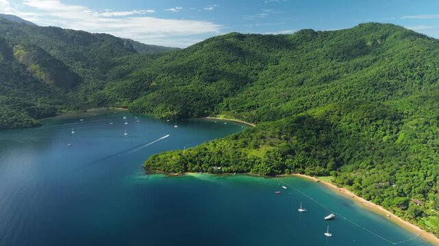 Aerial view of the calm and green lagoon with sailing boats on the island of Ilha Grande, Brazil