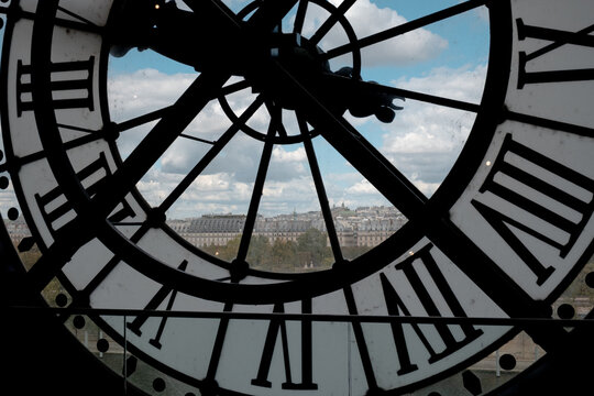 Mus&eacute;e d'orsay clock overlooking paris cityscape and montmartre, time passing in historical architecture