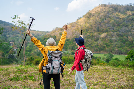 Caucasian hikers enjoying their success at the top on a mountain trail.