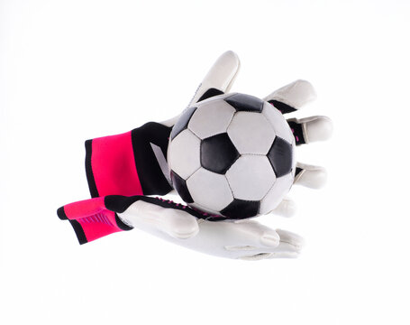 Soccer ball and goalkeeper gloves isolated on a white background.