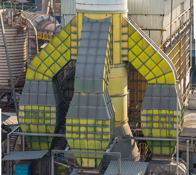 Aerial view of massive industrial ventilation ducts and processing infrastructure at a manufacturing facility in Brescia, Lombardy, Italy.