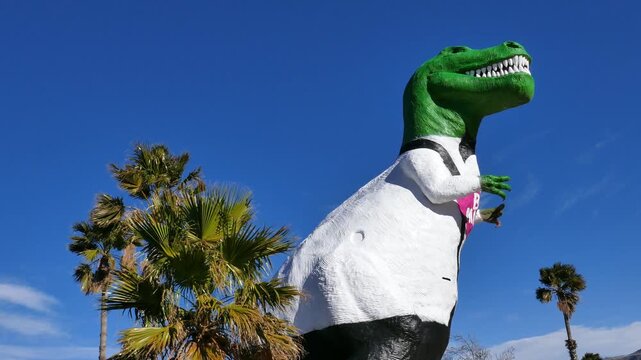 Large dinosaur sculpture roadside attraction along highway 10 in Cabazon, California. Mr. Rex, a Tyrannosaurus Rex. Painted in Valentine's day themed tuxedo colors.