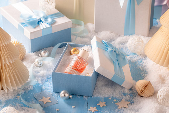 Rare perfume is shown outside in freezing Christmas winter backdrop.