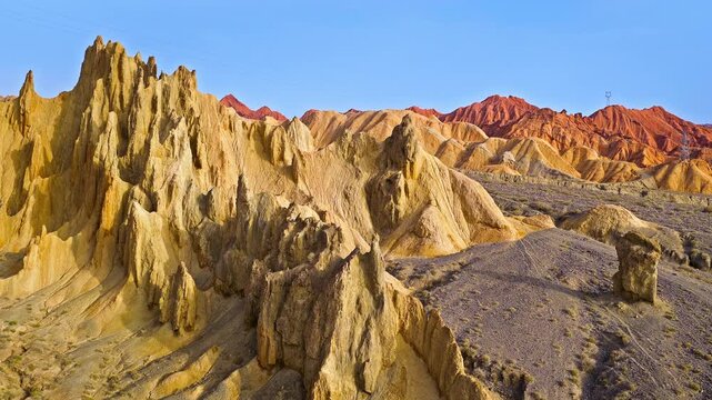 Aerial view of sandstone rock formations and arid mountain canyon landscape under a clear blue sky, Kuqa, Xinjiang, China