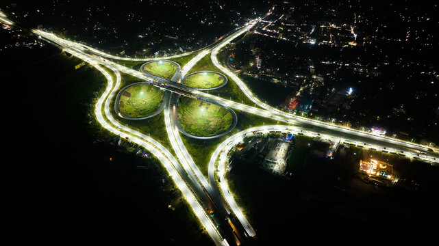 Aerial view of an illuminated highway interchange at night with glowing street lights and traffic lanes in Narail, Khulna Division, Bangladesh.