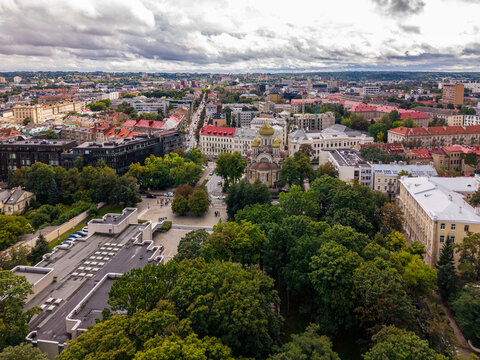 Aerial view of the Church of St. Michael and St. Constantine surrounded by historic buildings, lush trees, and urban streets in Vilnius, Vilnius County, Lithuania.