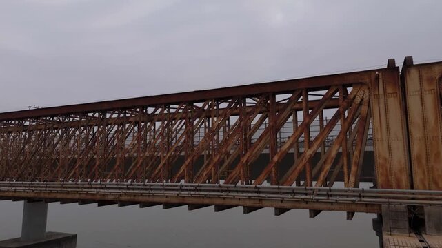 Close aerial view of golden bridge structure over river in Bharuch, Gujarat, India