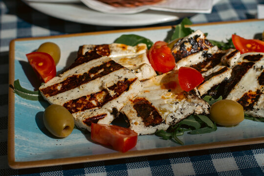 Grilled cheese plate with cherry tomatoes and olives