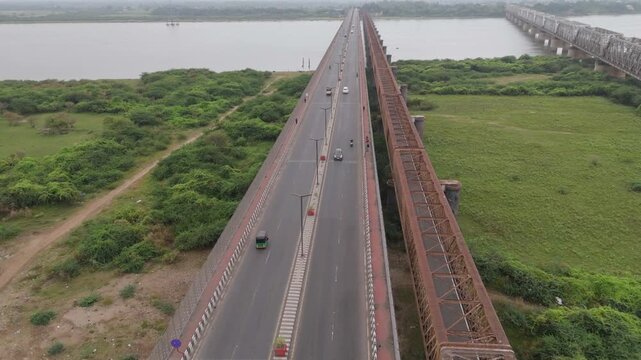 Aerial drone view of long highway bridge crossing river and green landscape in Bharuch, Gujarat, India