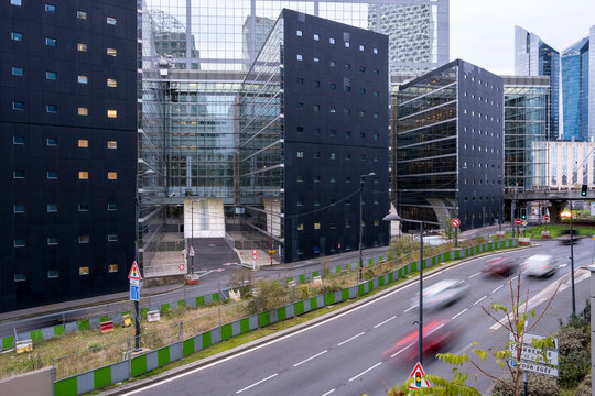 Office buildings above an urban road in La Defense district of Paris France showing contemporary business architecture and city infrastructure