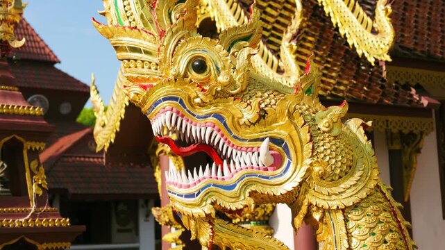 Slow Motion Close-Up of a Golden Naga Statue at a Traditional Thai Temple