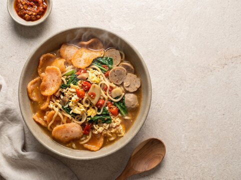 Photorealistic Indonesian seblak with spicy crackers, noodles, egg, and vegetables, arranged for food advertising, restaurant menus, culinary campaigns, and editorial design