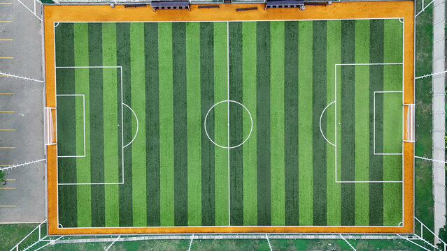 Aerial view of a mini soccer field with green striped artificial turf and white markings in Tangerang, Banten, Indonesia.