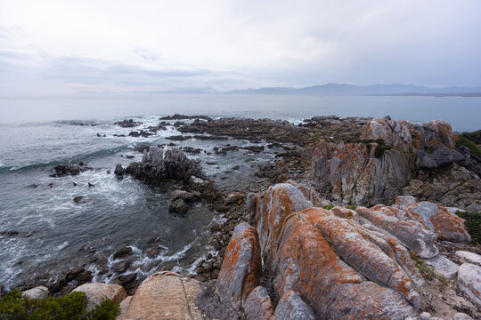 stormy late afternoon light on rocky coastline of DeKelders, South Africa