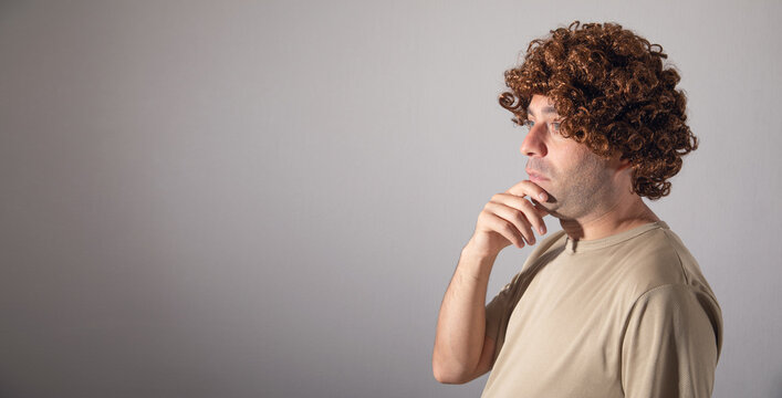 Caucasian young man wearing wig.