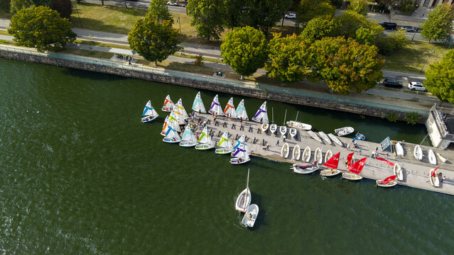 Aerial view of colorful sailboats docked at a pier on the Charles River in Cambridge, Massachusetts, United States.
