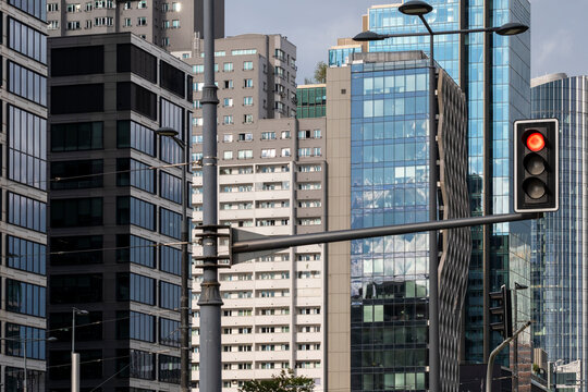 Traffic light in front of office buildings in the financial district of Warsaw Poland showing an urban business streetscape and modern towers