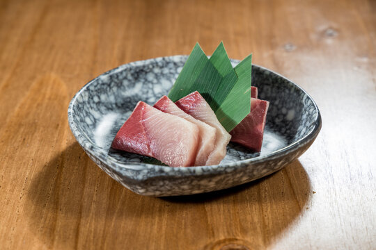 Tuna and yellowtail sashimi on stone plate
