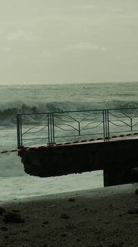 Ocean waves destroy beachfront buildings during storm surge weather