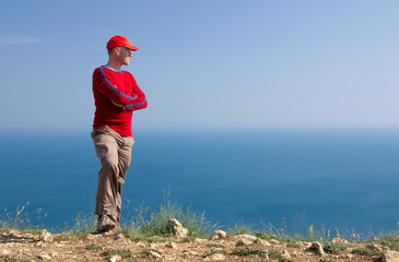 A young man stands on a cliff © Nemeziya
