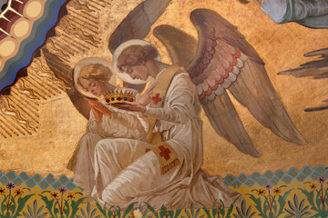Fototapeta premium Monza - The fresco of angel adorated Jesus the Pantokrator in main apse of the church Chiesa di San Carlo by Grandi from year 1925.