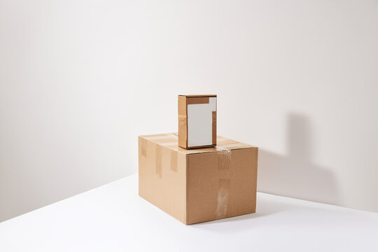 Cardboard shipping boxes with blank mockup label on white background