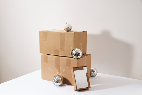 Stack of Cardboard Shipping Boxes with Holiday Ornaments for Christmas Delivery Concept
